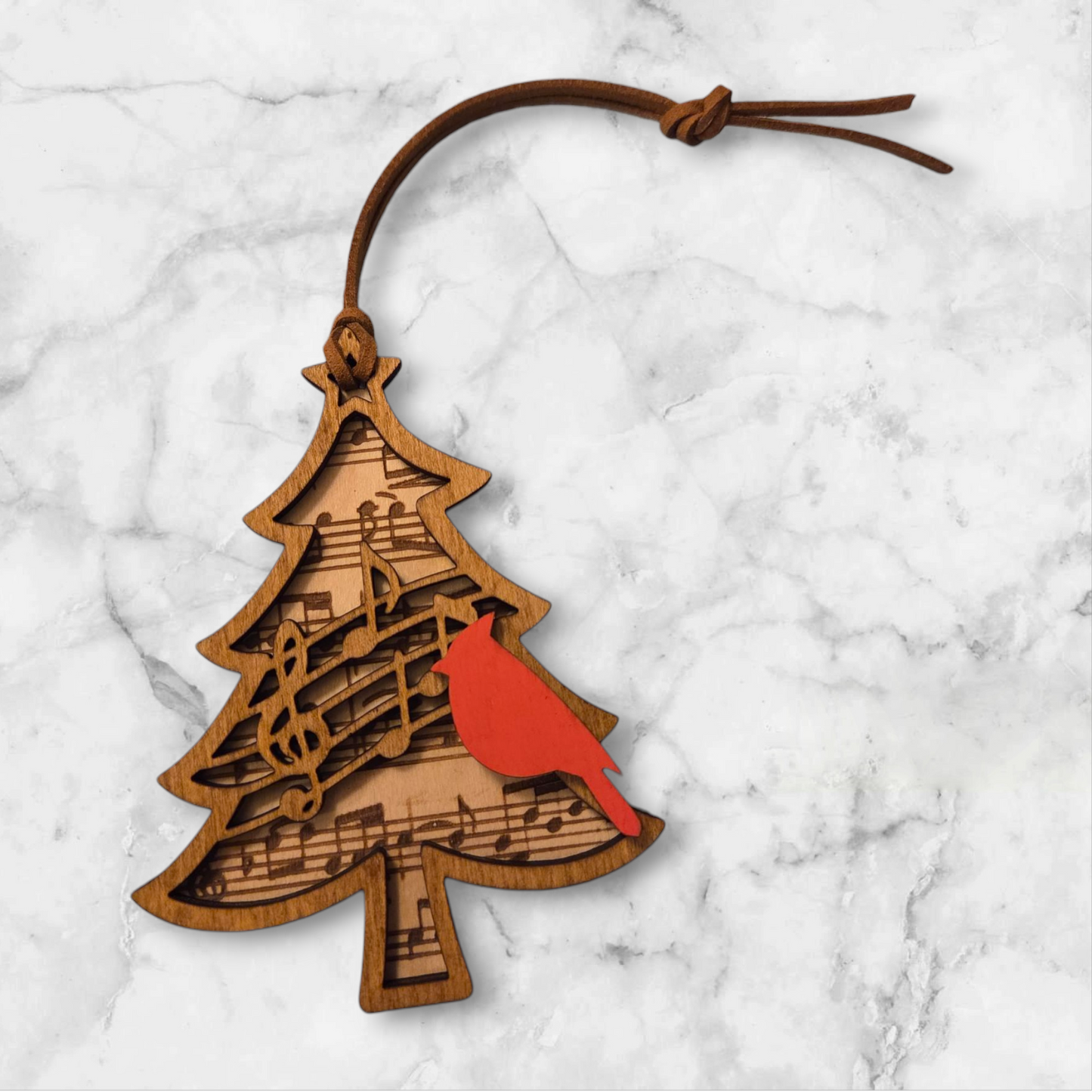 Wooden Christmas ornament with red cardinal and musical notes.