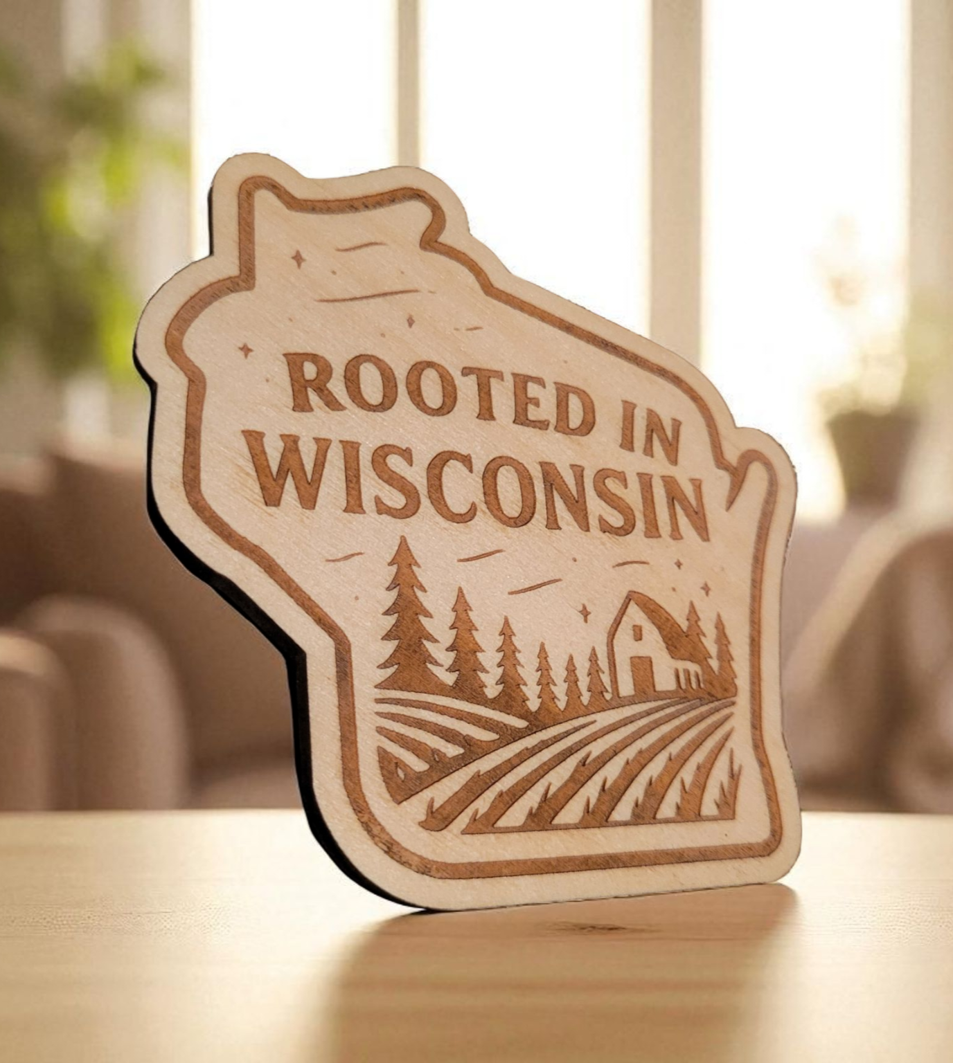 State-shaped wood magnet engraved with “Rooted in Wisconsin” and a farm scene with trees and barn.