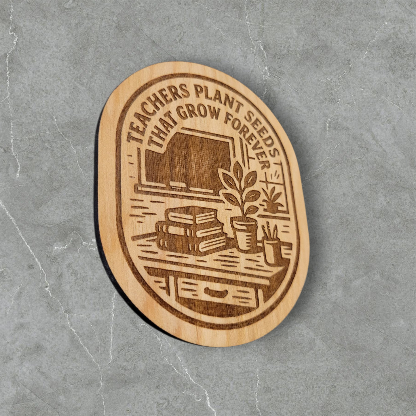 Engraved wood magnet featuring “Teachers Plant Seeds That Grow Forever” with classroom books, plant, and chalkboard illustration