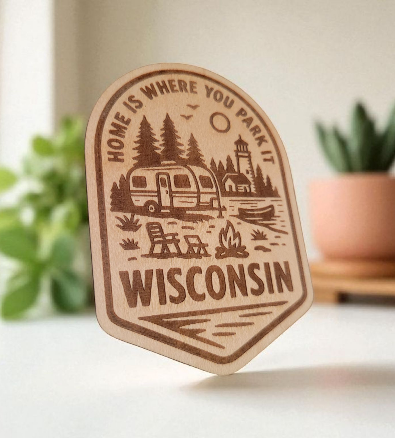 Wood magnet engraved with camper, pine trees, and fire pit, and the phrase “Home is where you park it – Wisconsin.”