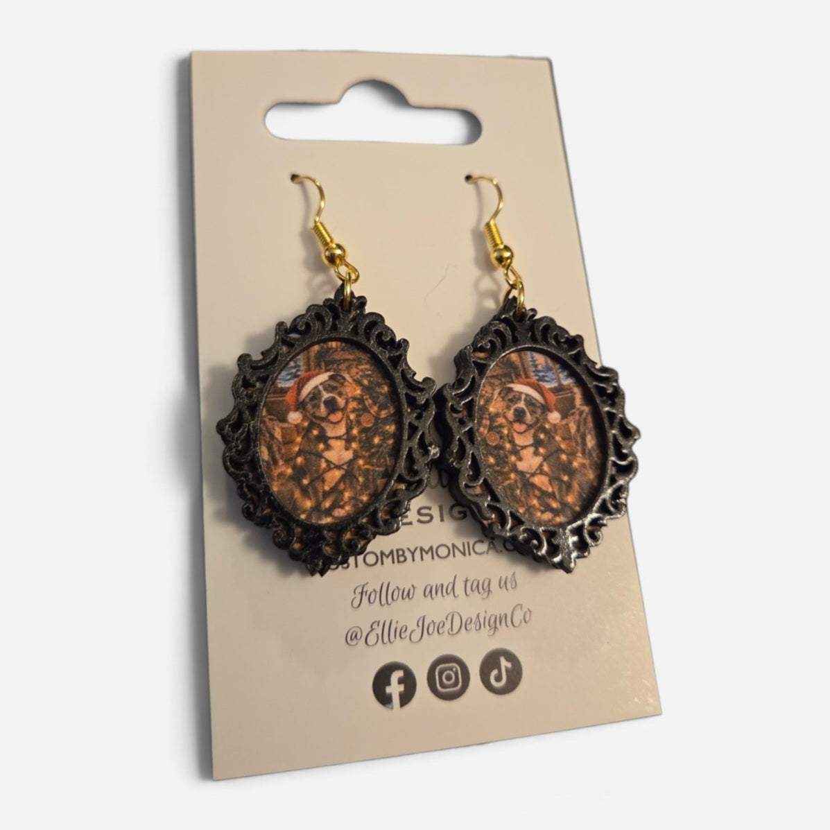 Christmas pup miniature art dangle earrings with colorful holiday dog scenes inside ornate black frames and gold hooks by Ellie Joe Design Co.