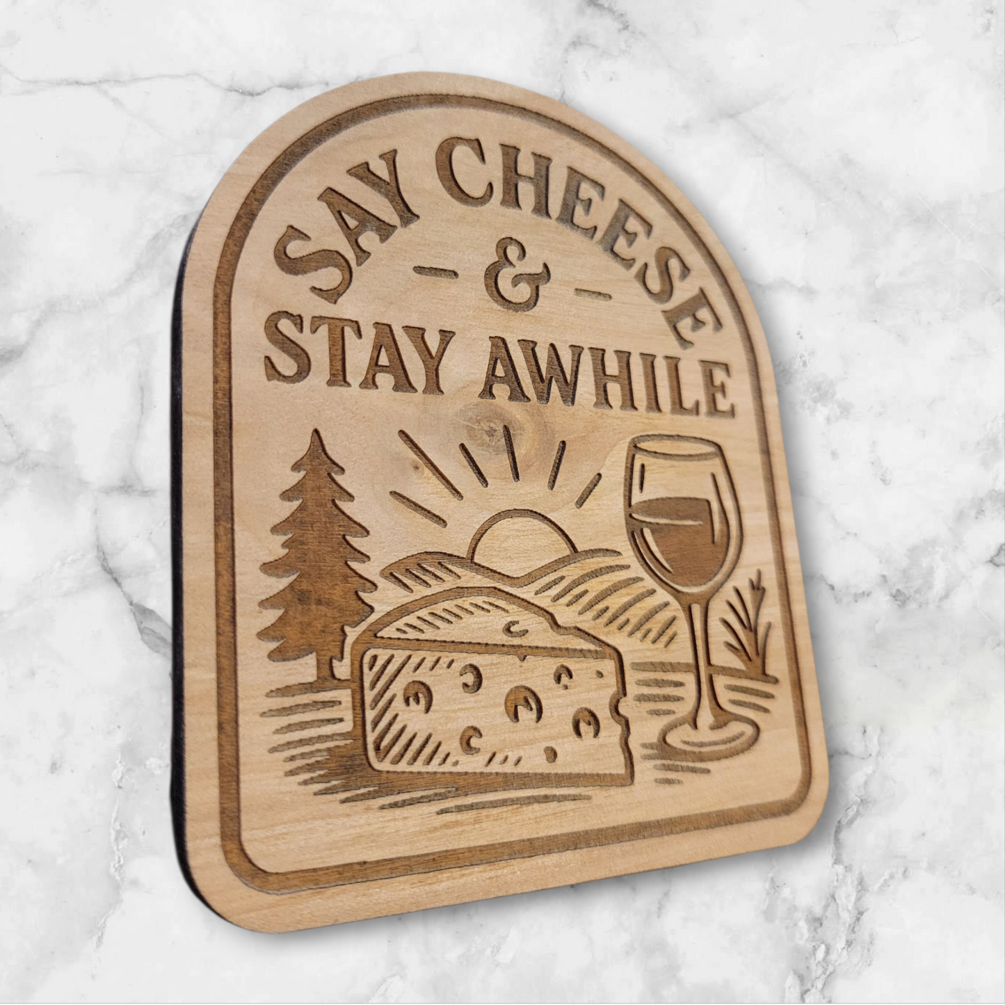 Close-up of engraved Wisconsin cheese and wine magnet on natural maple wood – handcrafted fridge magnet gift