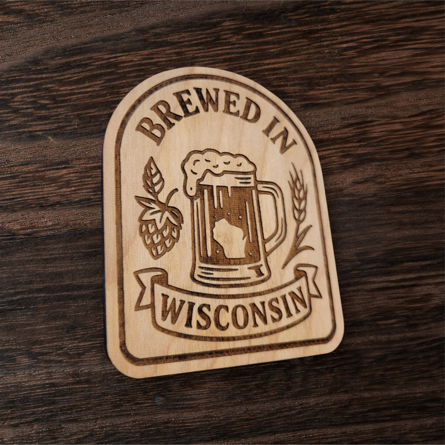 Laser-engraved wood magnet with beer mug, hops, and wheat, reading “Brewed in Wisconsin”