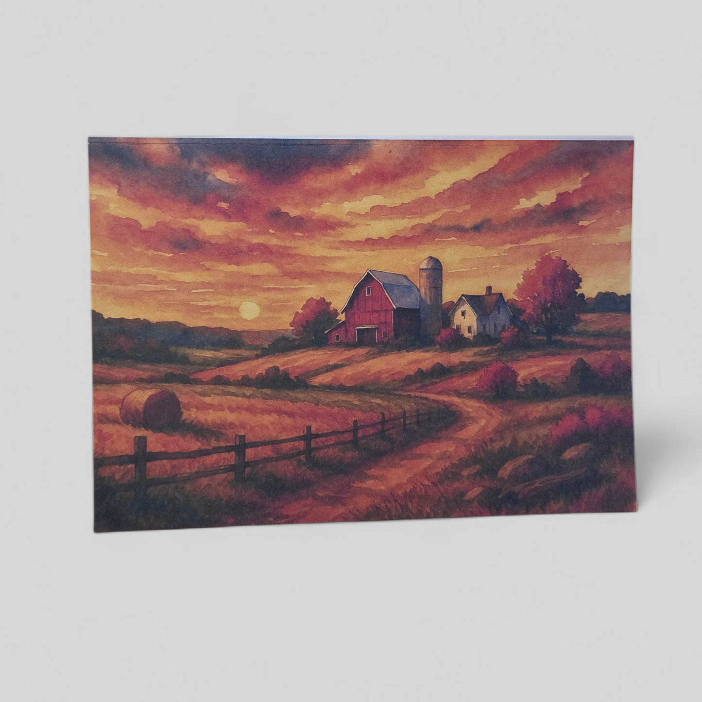 Greeting card featuring a warm Wisconsin barn sunset scene on wood table.