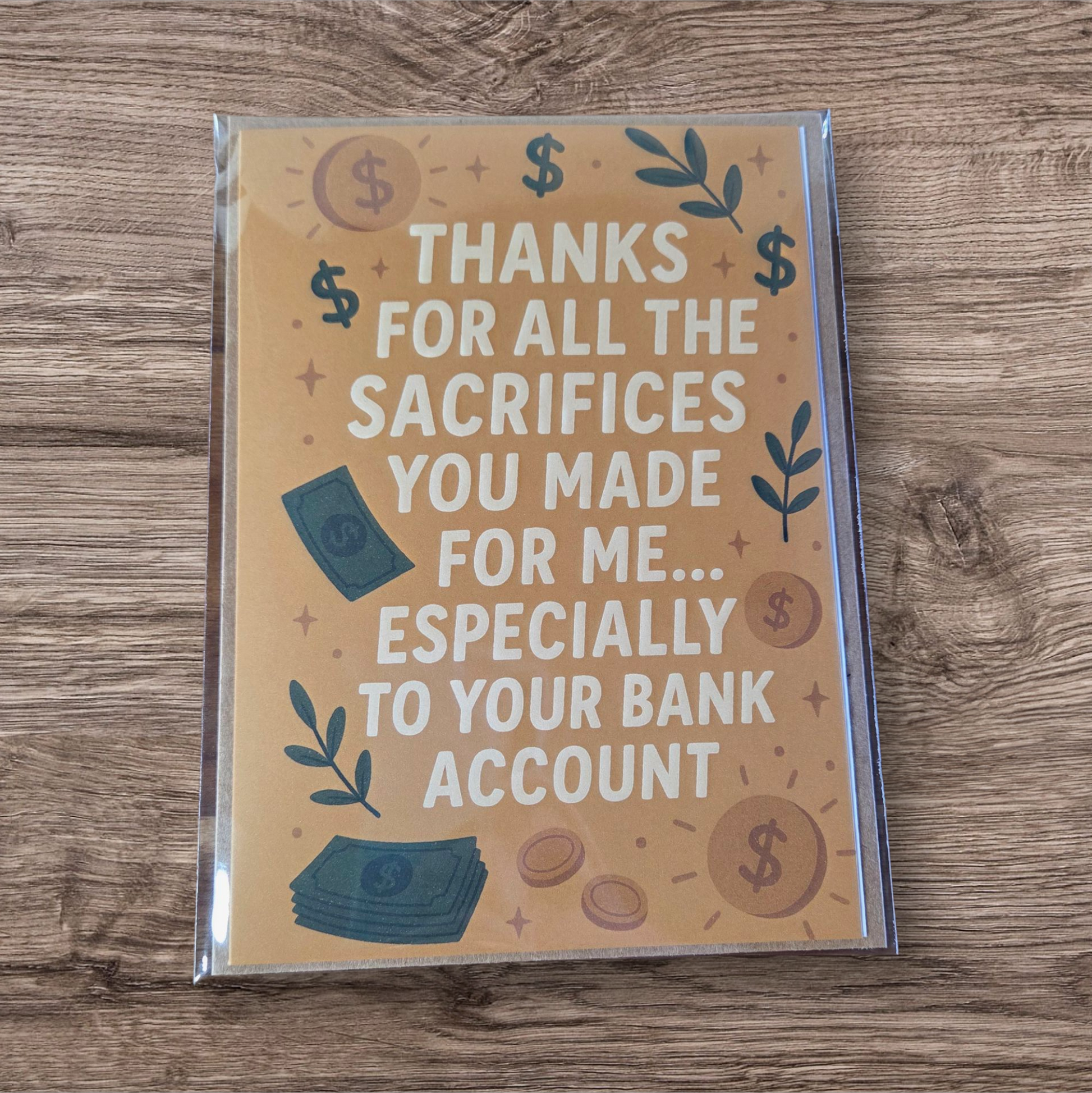 Greeting card reading ‘Thanks for all the sacrifices you made for me especially to your bank account’ with money and dollar sign illustrations.