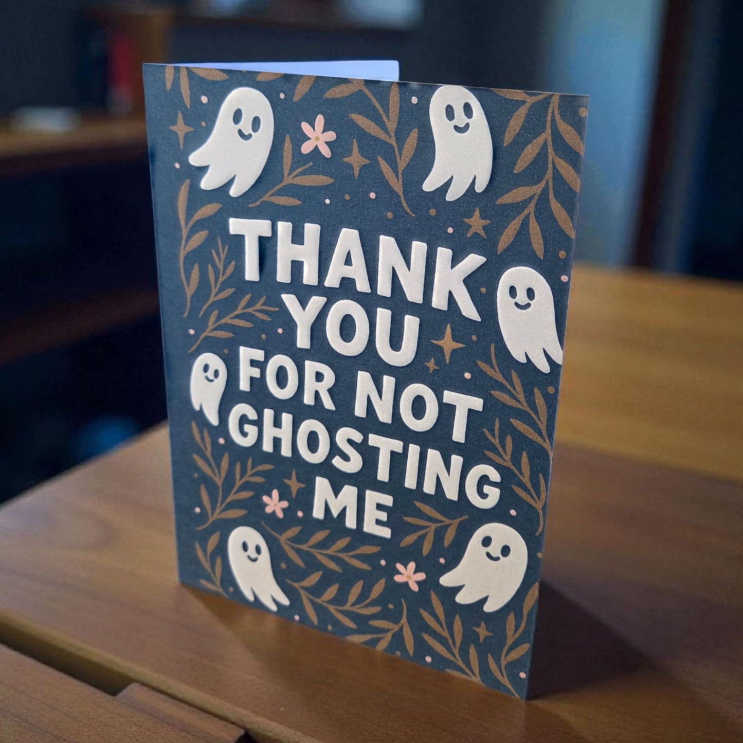 Greeting card reading ‘Thank You For Not Ghosting Me’ with cute ghosts and floral accents.