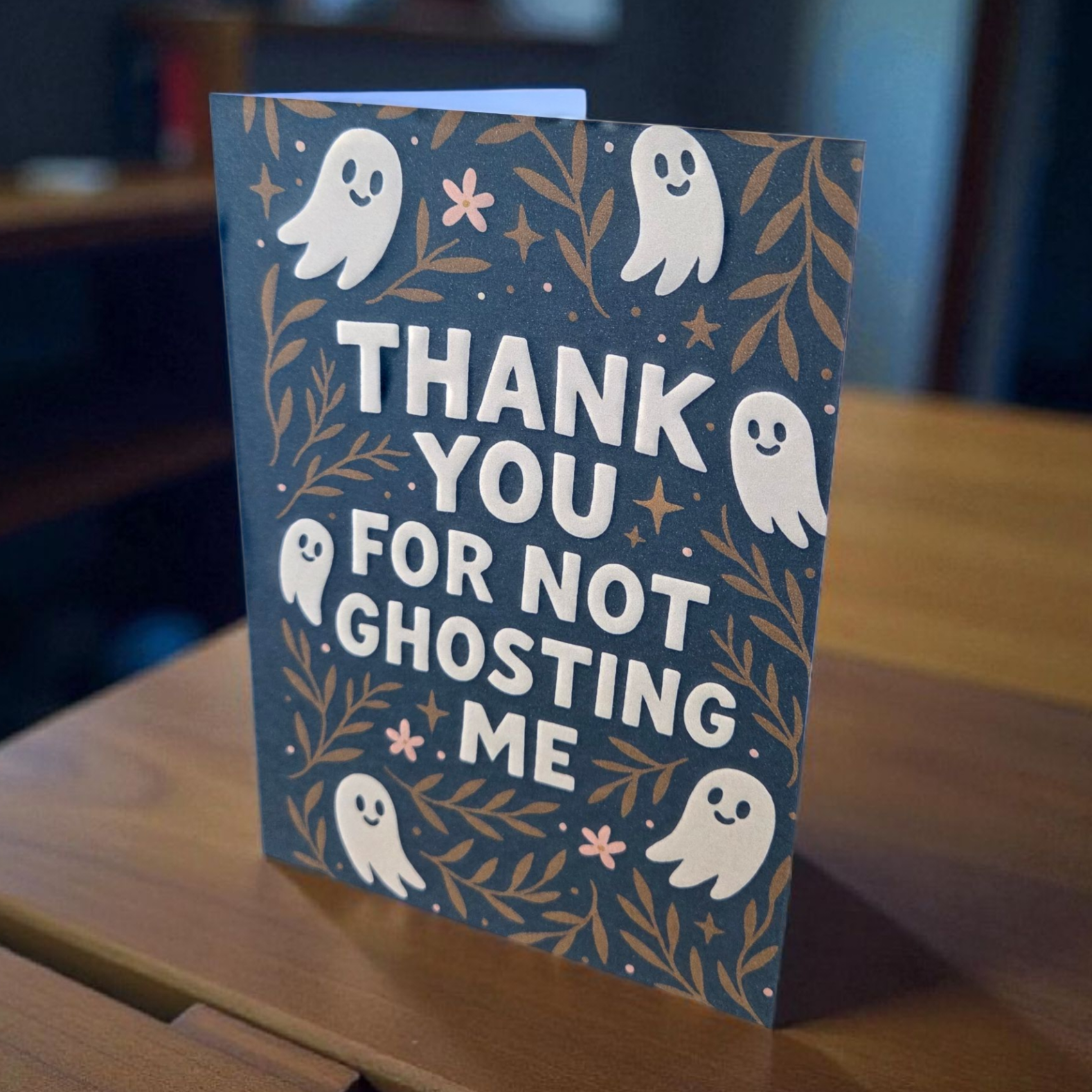 Greeting card reading ‘Thank You For Not Ghosting Me’ with cute ghosts and floral accents.