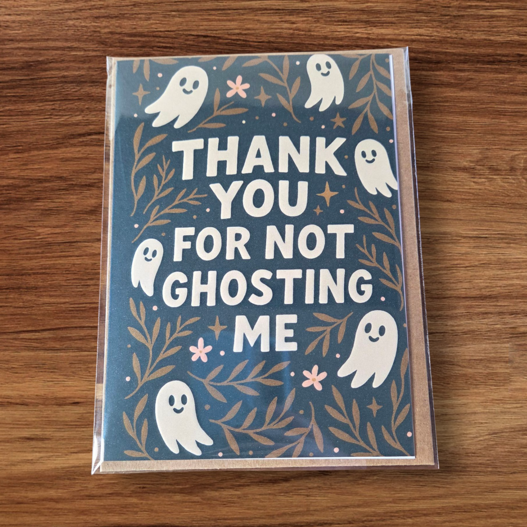 Greeting card reading ‘Thank You For Not Ghosting Me’ with cute ghosts and floral accents.