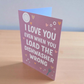 Funny greeting card reading ‘I Love You Even When You Load the Dishwasher Wrong’ on pink background with hearts.