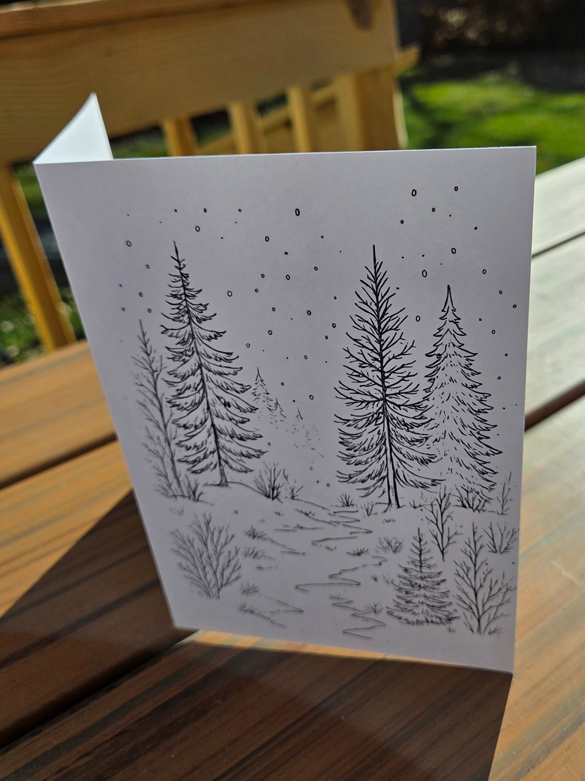 Winter cabin line-art card printed on watercolor paper, designed for painting or coloring.