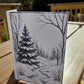 Winter cabin line-art card printed on watercolor paper, designed for painting or coloring.