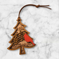Wooden Christmas ornament with red cardinal and musical notes.