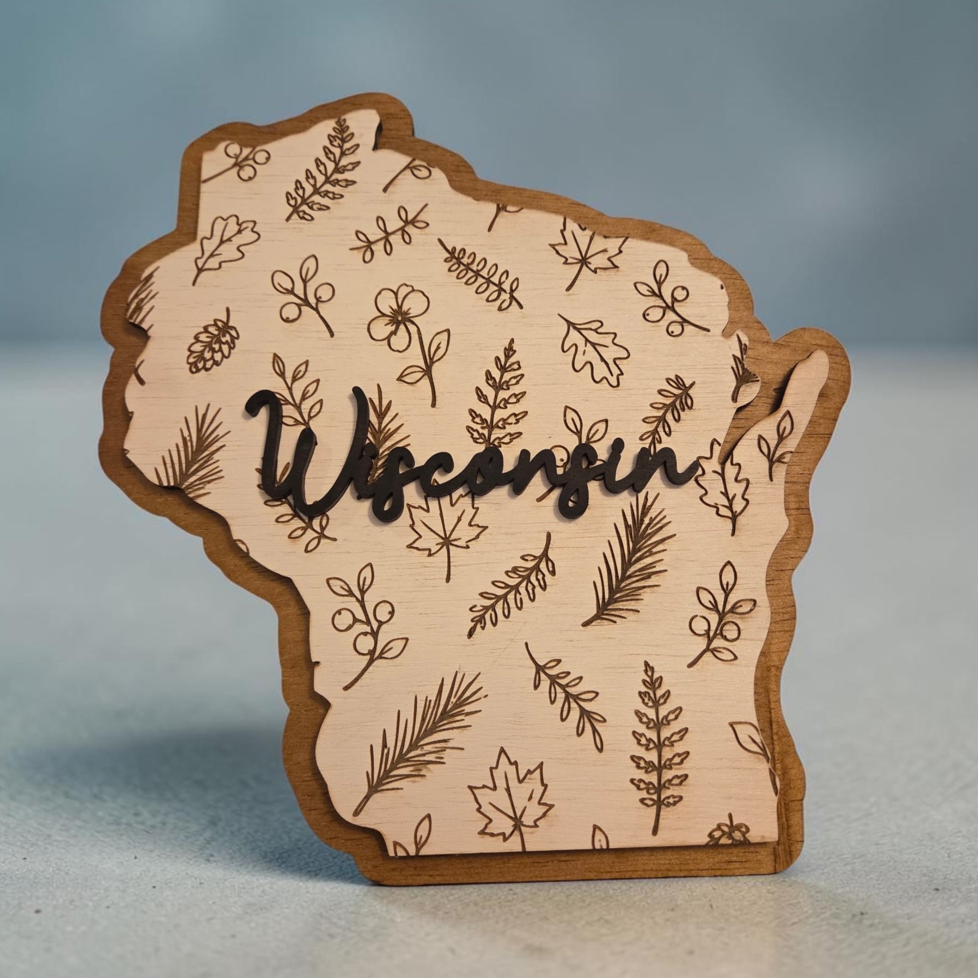 Wisconsin botanical two-layer wood sign with engraved leaves and raised Wisconsin lettering