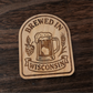 Laser-engraved wood magnet with beer mug, hops, and wheat, reading “Brewed in Wisconsin”