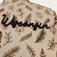Wisconsin botanical two-layer wood sign with engraved leaves and raised Wisconsin lettering