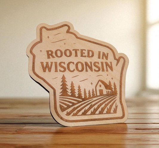 State-shaped wood magnet engraved with “Rooted in Wisconsin” and a farm scene with trees and barn.