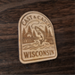 Laser engraved fishing magnet featuring a trout and cabin scene – Cast & Catch Wisconsin rustic wood design