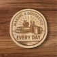 Laser engraved wood magnet with the phrase “Making a Difference Every Day” featuring an apple, books, pencils, and coffee mug