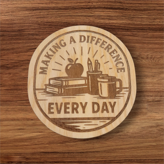 Laser engraved wood magnet with the phrase “Making a Difference Every Day” featuring an apple, books, pencils, and coffee mug
