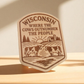 Wood magnet with engraved cows, barn, and the phrase “Wisconsin: Where the Cows Outnumber the People.”