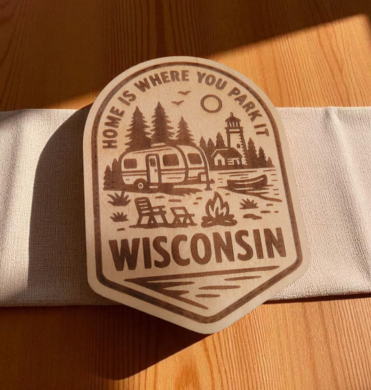 Wood magnet engraved with camper, pine trees, and fire pit, and the phrase “Home is where you park it – Wisconsin.”