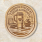 Wood magnet engraved with “Classroom Fueled by Coffee & Kindness,” featuring a coffee tumbler, books, apple, and classroom items