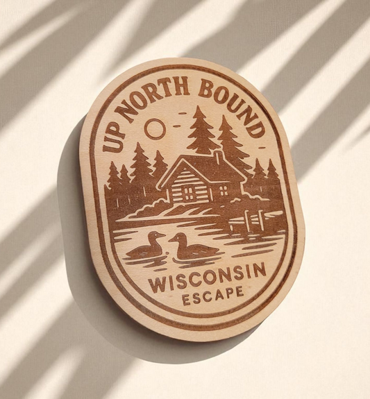 Wood magnet engraved with a lakeside cabin, pine trees, loons, and the words “Up North Bound – Wisconsin Escape.”