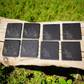 Rustic set of 4 square slate coasters, laser engraved with olive branch sprigs or a wine-and-cheese scene. Natural slate stone with etched line art design, perfect for protecting tables in style.